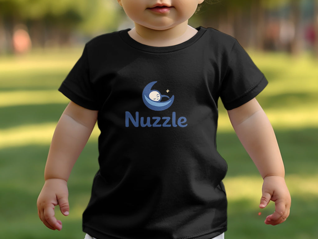 Black toddler t-shirt with blue crescent moon and sleeping baby logo and "Nuzzle" text.