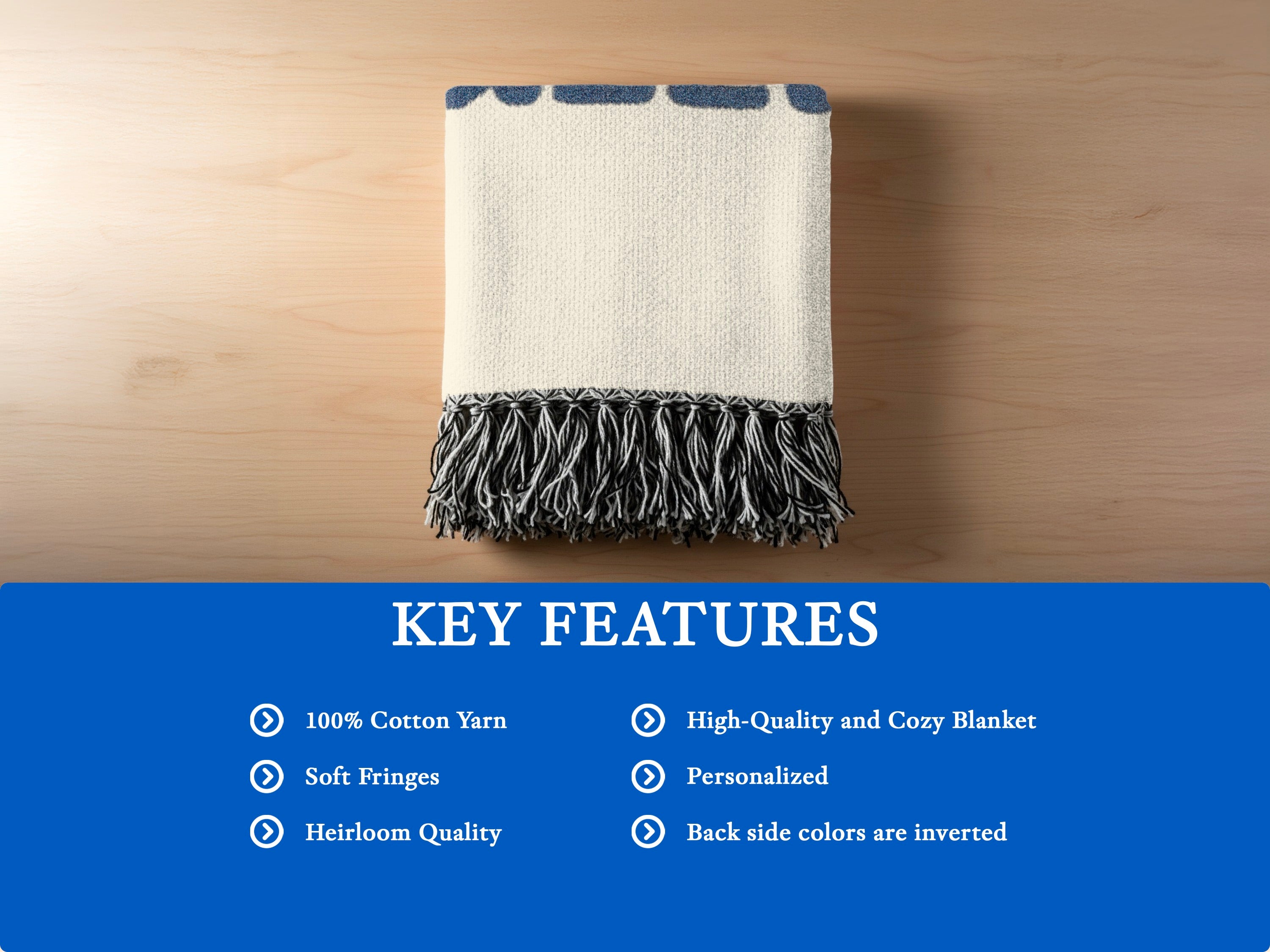 Cream blanket with blue patterned edge and black and white fringes, 100% cotton.