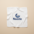 White baby blanket with Nuzzle moon logo printed in center