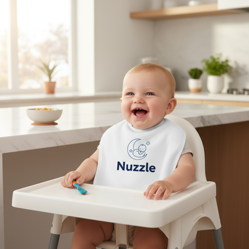 Baby wearing white Nuzzle bib with logo during mealtime